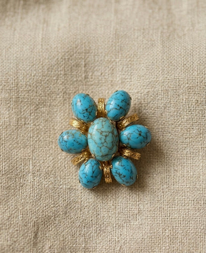 Broche fleur avec pierres bleues