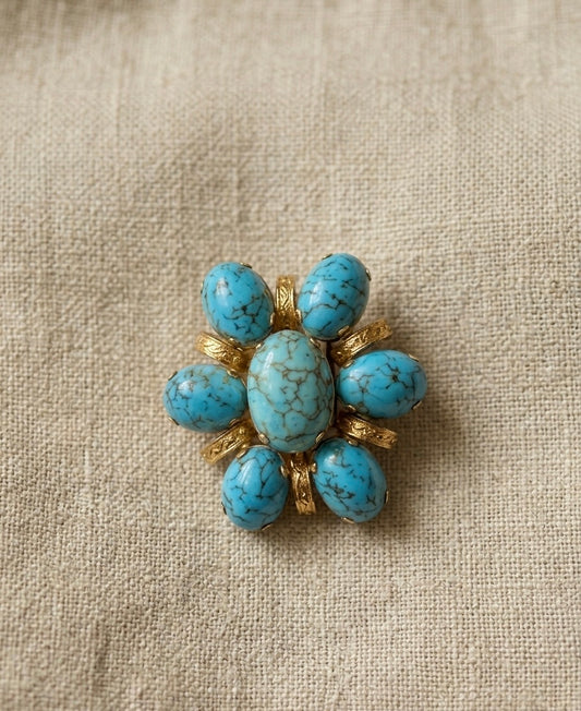 Broche fleur avec pierres bleues